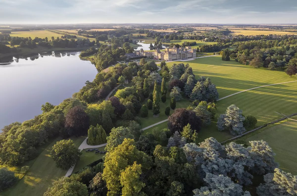 Blenheim Palace estate from above showing the grand manor house, geometric gardens, and surrounding countryside